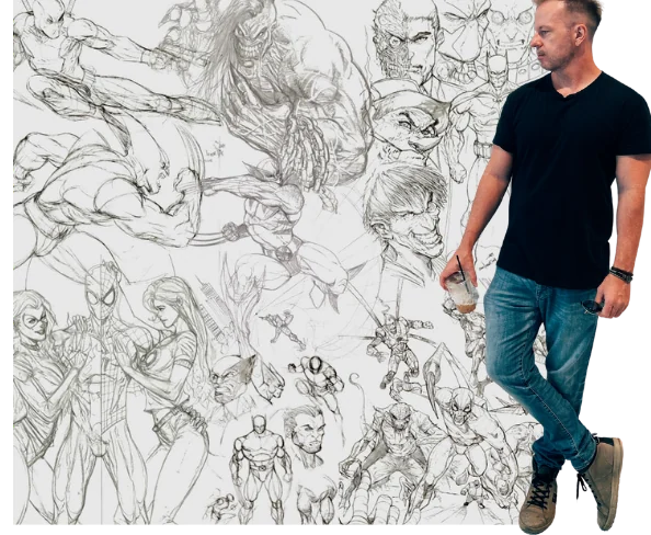 Mike Van Orden standing beside a wall of his comic pencil drawings