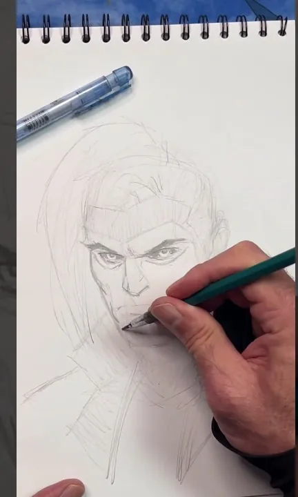 Mike sketching Gambit in a spiral sketchbook