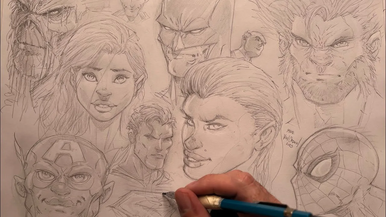 Mike's hand inking a sheet of comic heads